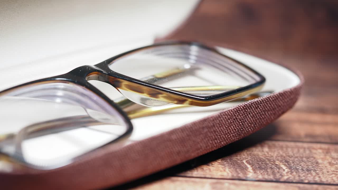 Eyeglasses in a Case on a Wooden Table