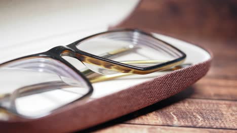 eyeglasses in a case on a wooden table