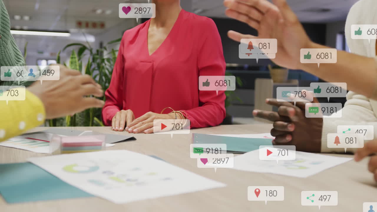 Discussing animation, people in office with social media icons floating around