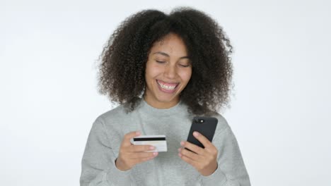 online shopping on smartphone by young african woman, white background