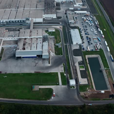industry on field. large territory of a manufacturing with car parking on fields background. aerial view.