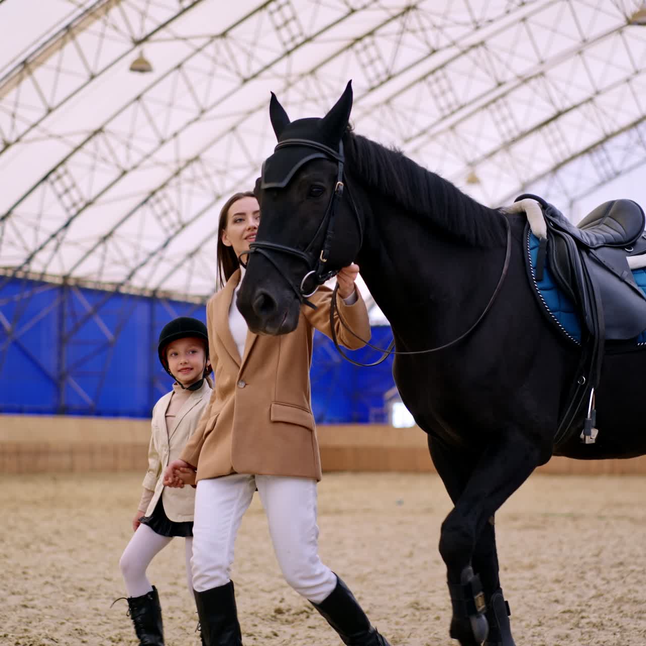 Horse riding education with instructor. Young lady with child horse ride