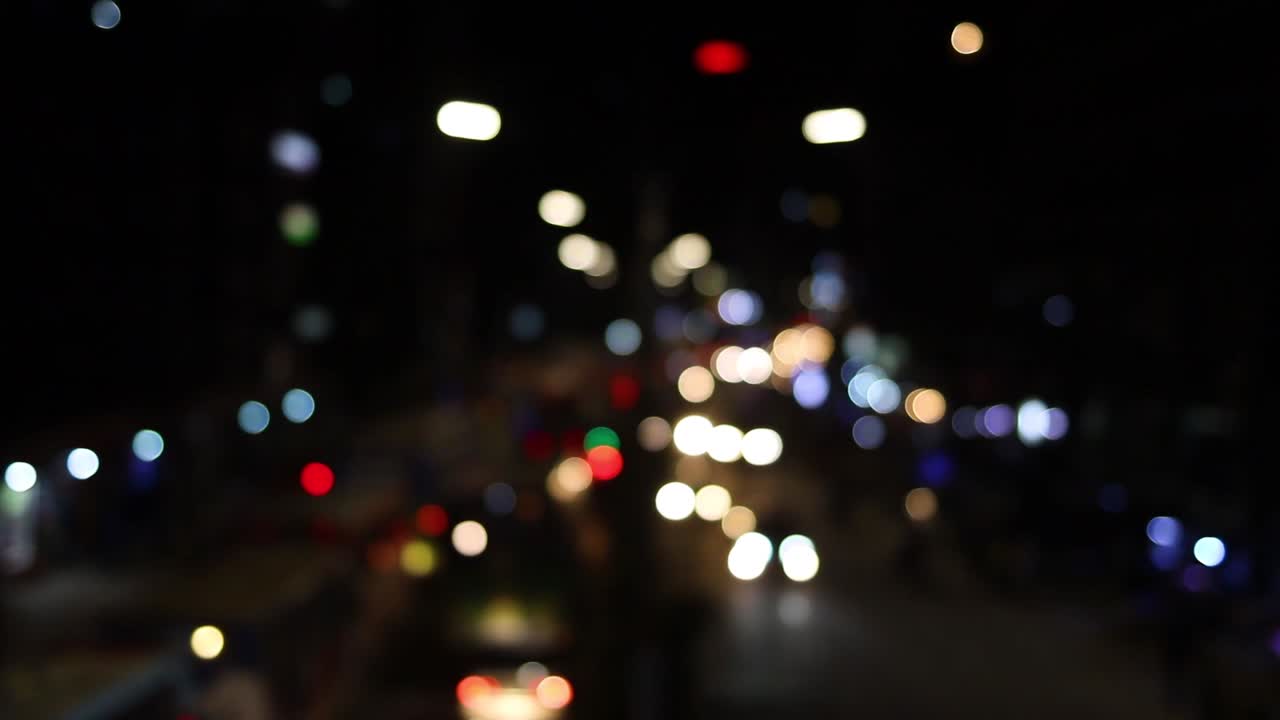 timelapse de las luces bokeh de los vehículos de tráfico en las calles urbanas por la noche en la ciudad de dhaka, bangladesh