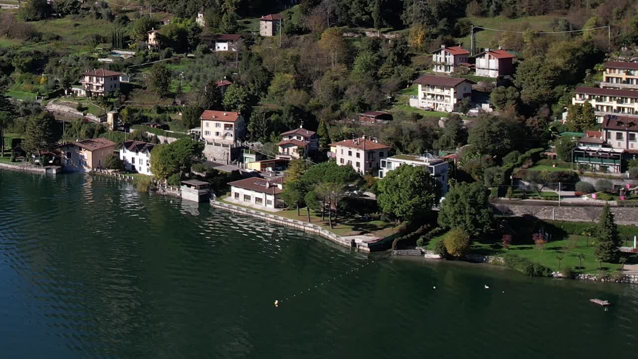 Breathtaking aerial view of tranquil lake and charming homes in the Alps