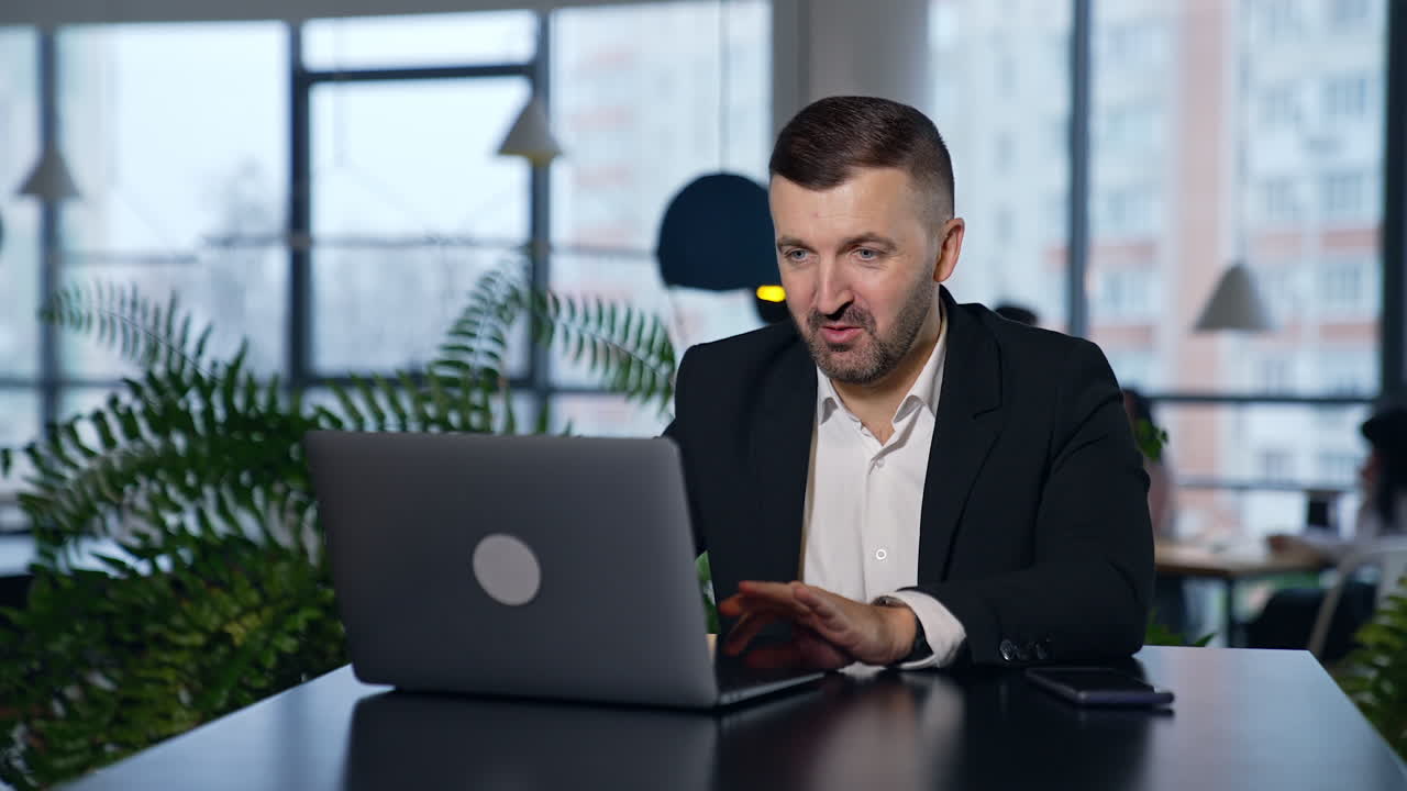 Succesfull businessman working in modern office. Handsome smart man with laptop.