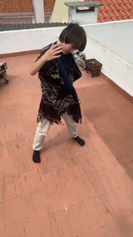 child dancing on a rooftop