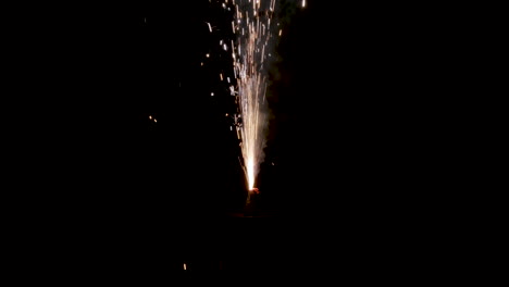 sparks flying from sparkler firework in darkness