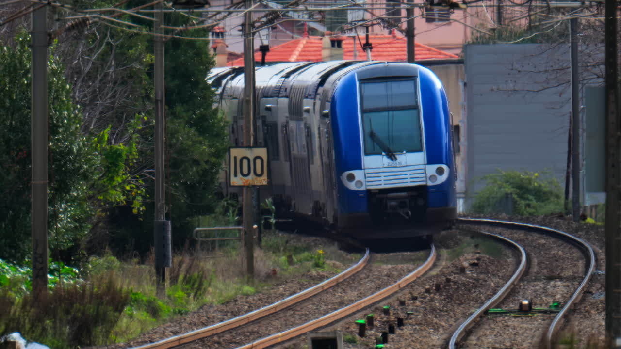Cannes, France - February 4, 2025: Trains moving on the rails near a train station