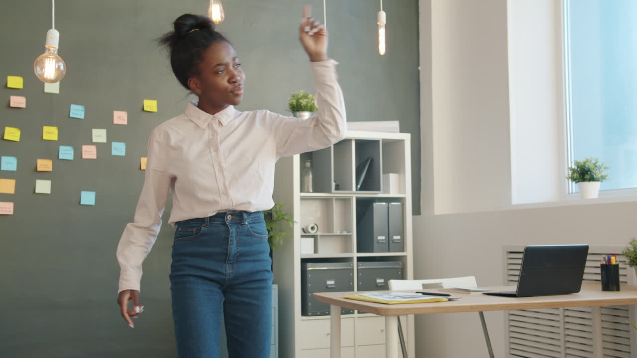 Happy Woman Dancing in Office
