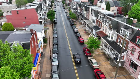 Aerial-view-of-car-driving-down-city-street