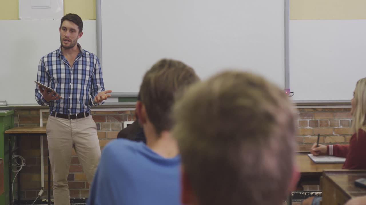 Teacher talking at his high school class