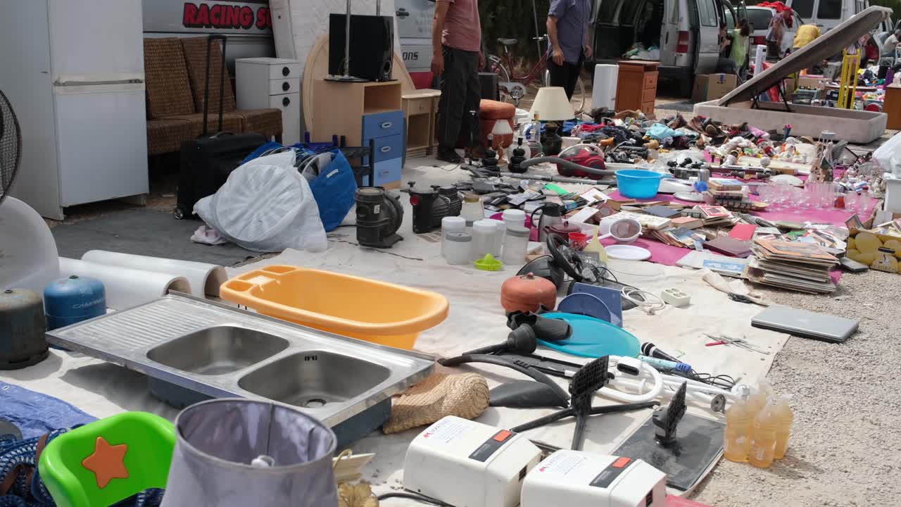 A diverse display of household goods, electrical items, and reusable materials fills the flea market, offering shoppers a wide array of unique, second-hand treasures to explore