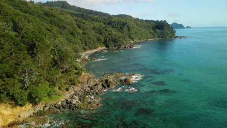 Slow-mo-aerial-footage-of-rocky-cliff-lined-coastal-beaches