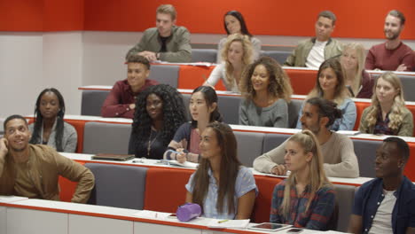 teacher addressing students in a university lecture theatre
