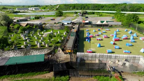 aerial view of paintball field with variety of obstacles in summer