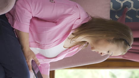 Vertical-video-of-The-woman-talking-on-the-phone-is-cold-next-to-the-cold-heater.