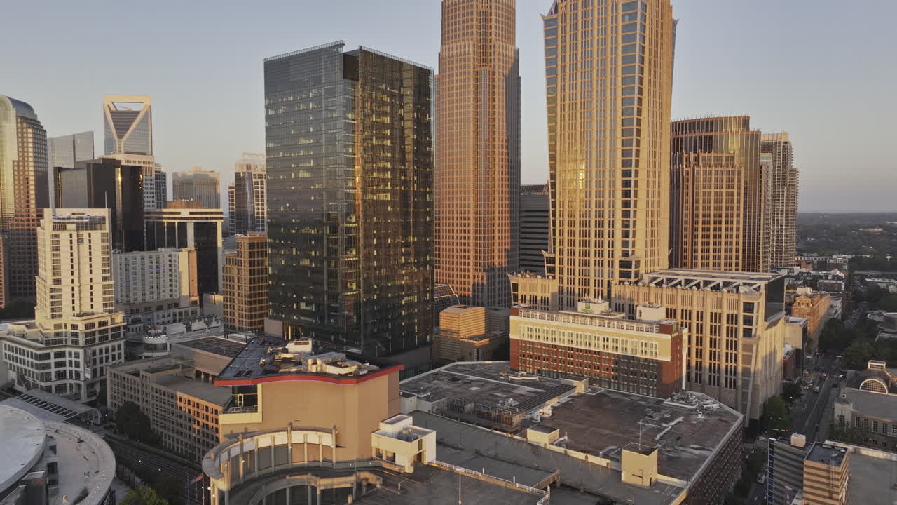 Charlotte North Carolina Aerial v159 low reverse flyover First ward capturing uptown cityscape featuring Spectrum Center and commercial towers at sunrise - Shot with Mavic 3 Pro Cine - Oct 1st 2023
