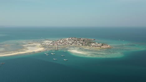 gili meringkik a small island community in middle of blue sea of lombok, aerial