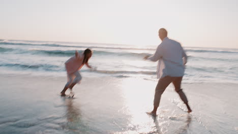 love, water splash and sunset with couple at beach