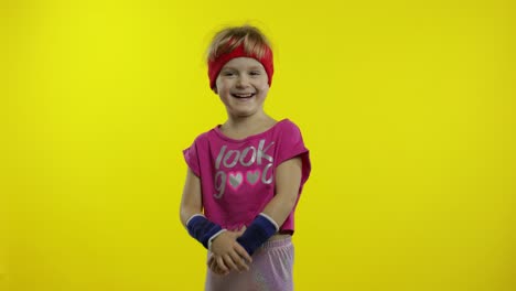 Little-happy-caucasian-girl-in-pink-sportswear-smiles,-laughs.-Workout-for-kids.-Young-sporty-child