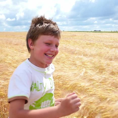 boy running through a wheat field