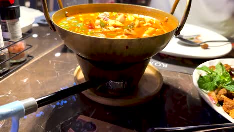 spicy prawn soup being prepared and served