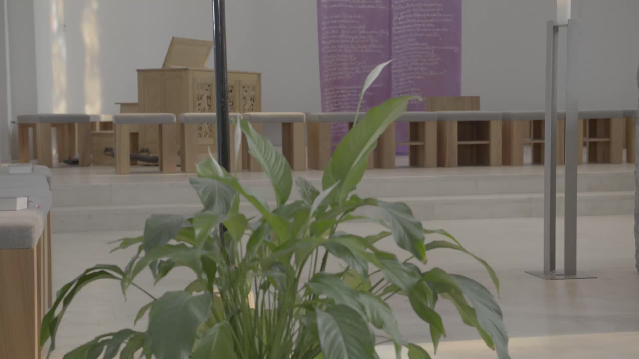 View inside a sanctuary in a church during Lent, veiled cross, camera pan