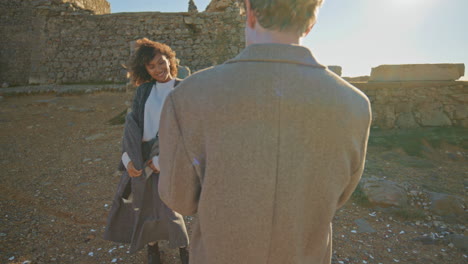 inspired photographer making photo on evening beach closeup. carefree newlyweds