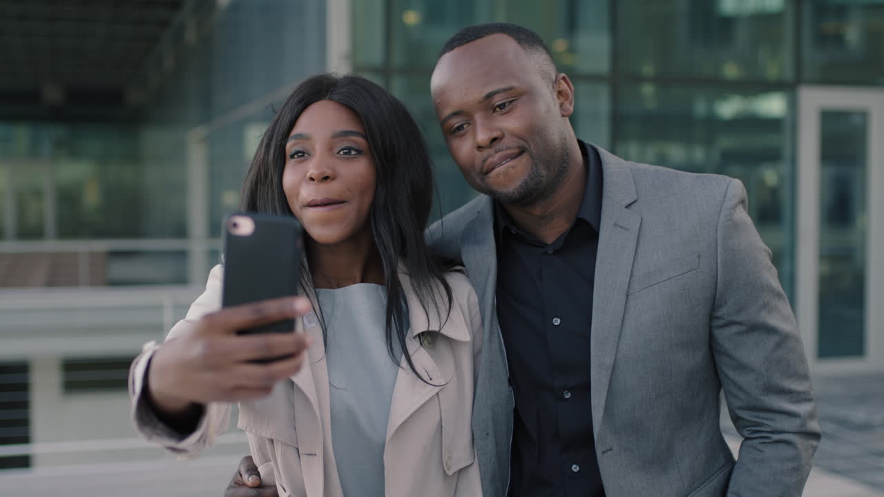 close up portrait of african american couple taking selfie funny photo happy couple