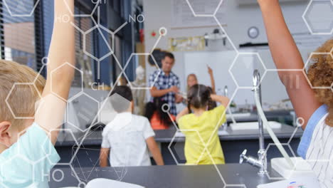 Animation of chemical icons over diverse schoolchildren raising hands in classroom