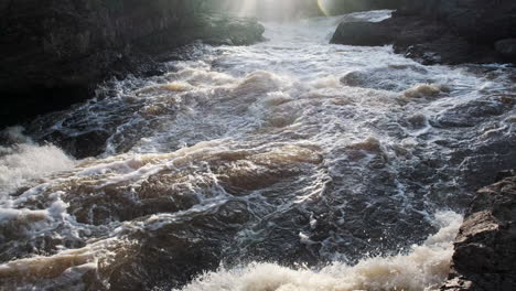 sunset lens flare over raging river rapids