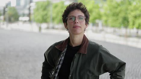 woman adjusting jacket and looking at camera