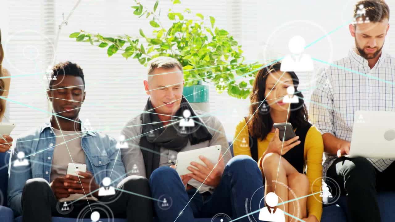 Swiping team on blue couch tapping devices in office lounge, network graphics forming connections