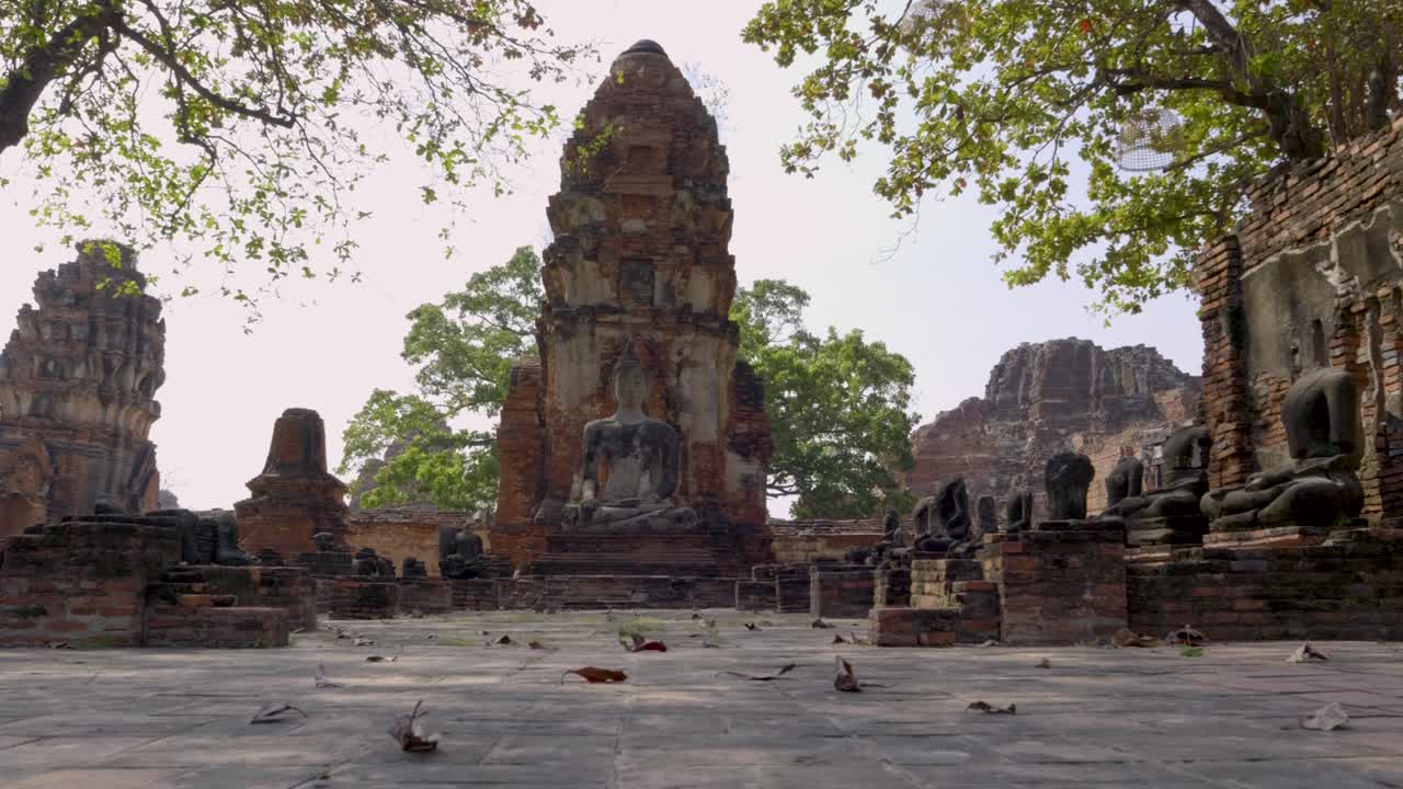 Incredible low angle slow motion slider over Buddha statue at temple in Ayutthaya, Thailand