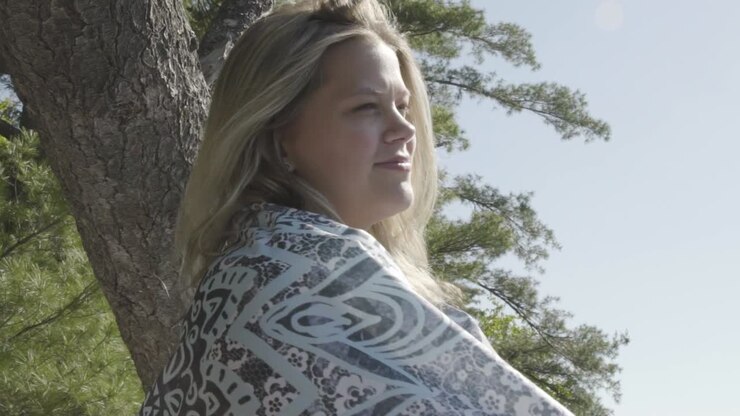 Happy young millenial woman outdoor in nature looks behind on sunny day at beach, closeup, slow motion