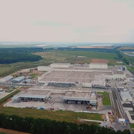 aerial view of a factory or industrial area surrounded by green fields. modern industrial factory