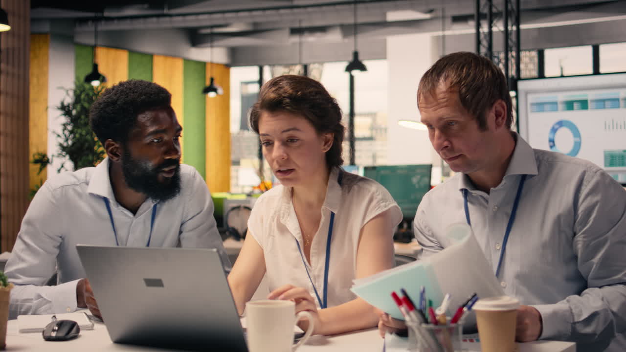 Professional team, meeting in office workspace, visual data and charts,