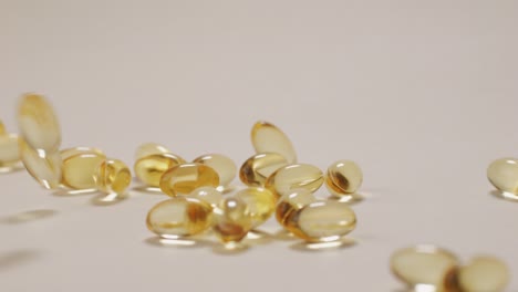 omega fish oil pills dietary supplement falling down on white background. omega fish oil softgels dietary supplement background. healthy life and heart health concept.