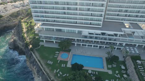 cinematic aerial footage of the swimming pool area of hotel allua soul, mallorca, spain