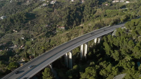 aerial: cars driving over highway bridge freeway in southern french, menton