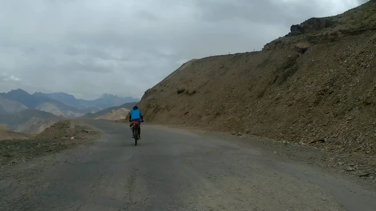 Cruising on a bicycle at Leh Ladakh Himalayas ghats pov