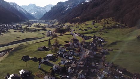 Aerial-view-of-a-small-village-nestled-amongst-the-large-mountain-range