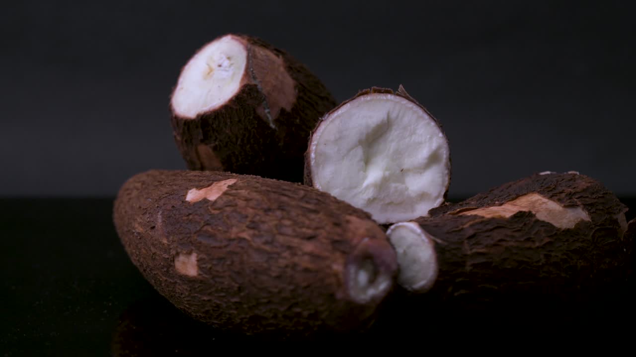 4K rotating close-up of fresh cassava root (yuca, manioc) cut open. A tropical starchy vegetable perfect for projects on exotic cuisine, agriculture, organic farming, nutrition, and root crops