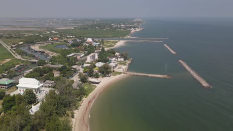 4k aerial drone footage along the coast of ban laem in phetchaburi on a beautiful summers day in thailand