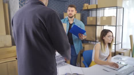 business partners working together at the warehouse of an online store.