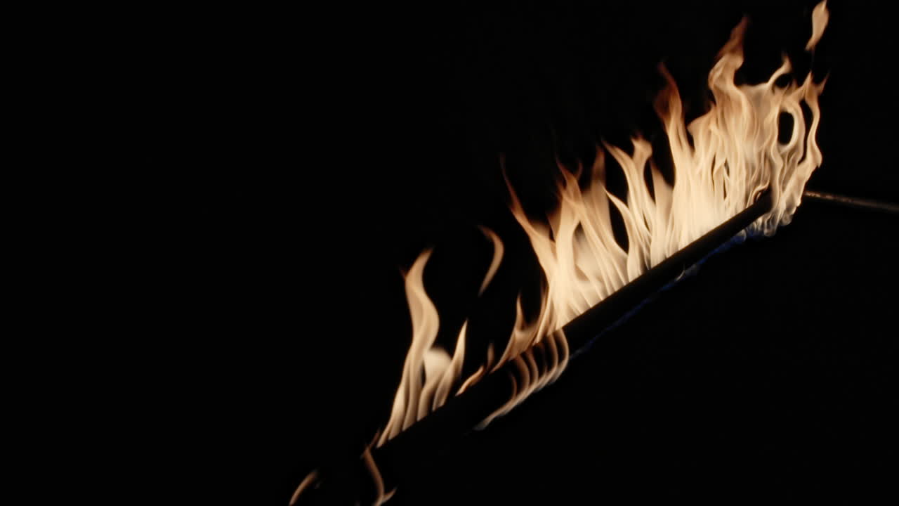 las llamas lamen la larga barra del