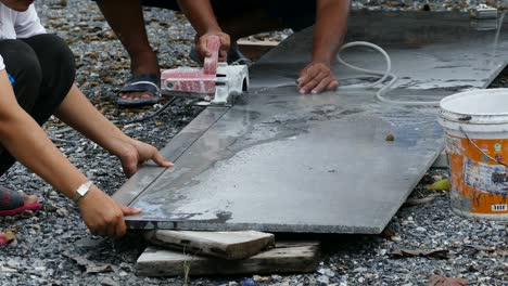 man cutting granite stone