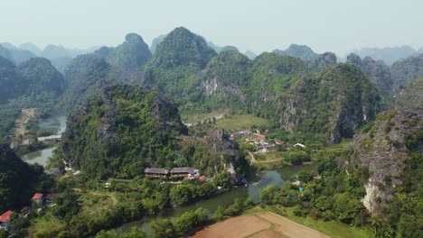 Aerial-Drone-View-of-Limestone-Mountain-Valley-Landscape-in-Vietnam-with-Farm-Land