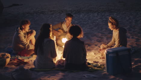 Beach-Party-at-sunset-with-bonfire-and-roasting-marshmellows-with-friends