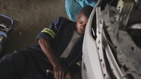 african man repairing car